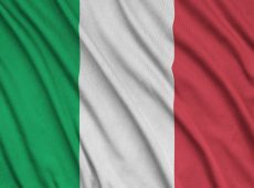 Italy flag is depicted on a sports cloth fabric with many folds. Sport team waving banner
