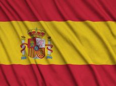 Spain flag is depicted on a sports cloth fabric with many folds. Sport team waving banner